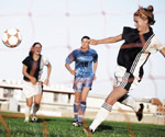 teenage girls playing football