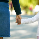 woman and child holding hands