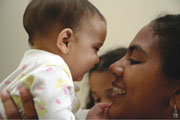 baby held by mother