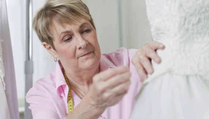 Woman sewing wedding dress